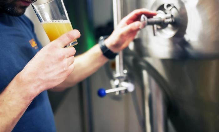 Our Brewer, Tom, sampling a beer before bottling.